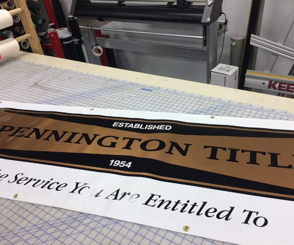 Pennington Title vinyl Banner laying on a work table