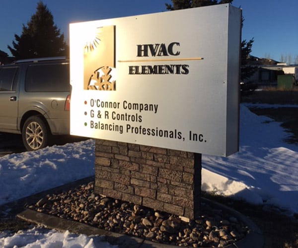 metal HVAC Elements Outdoor Sign on a brick stand