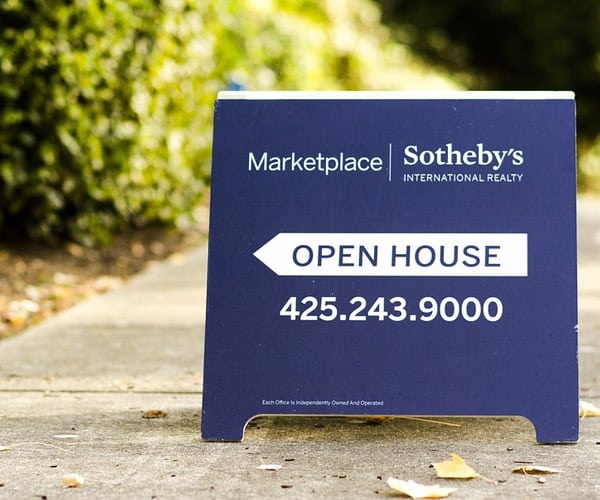 Navy blue Open House Sidewalk Sign on a sidewalk