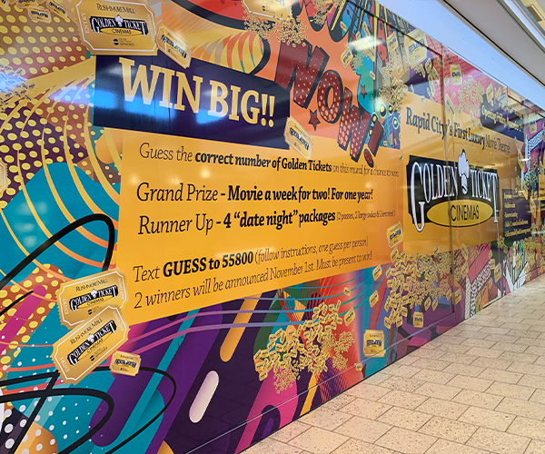 Wall advertisement for Golden Ticket Cinemas referring to a Golden Tickets contest to win movie tickets or date night packages